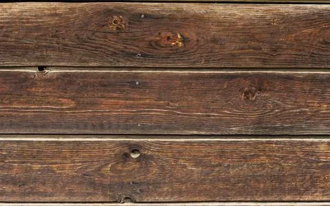 An old wheathered rustic braun dark oak wood texture. Boards with a knot. Gru Stock Photos