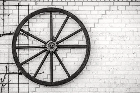 Old wheel hanging on a wall Stock Photos