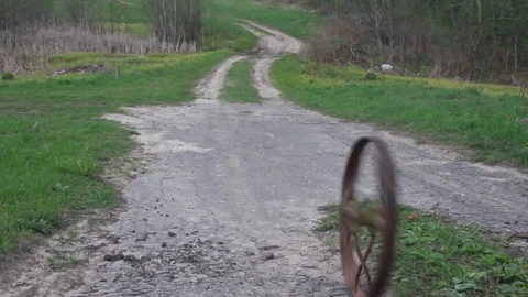 Old wheel on the road Stock Footage 73804633