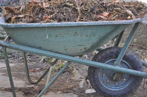 Old wheelbarrow with compost Stock Photos