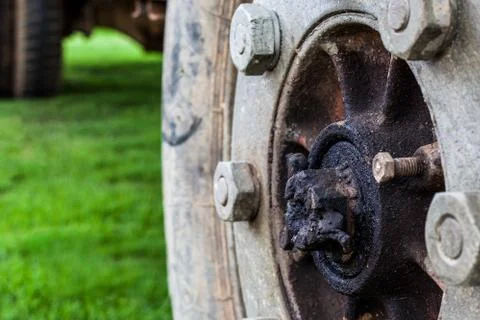 Old wheels on green background Stock Photos