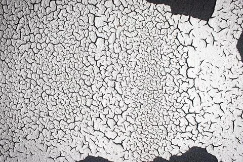 Old white and black paintwork on wall. Texture and backgroud cocept. Stock Photos