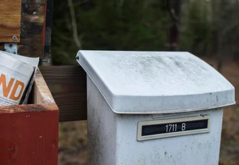 Old white and red mailboxes in the one of them Stock Photos