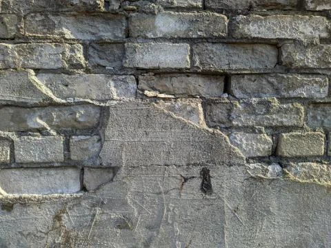 Old white brick wall half plastered background photo 스톡 사진