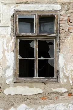 Old white broken window, on an old, ruined building. Stock-Fotos