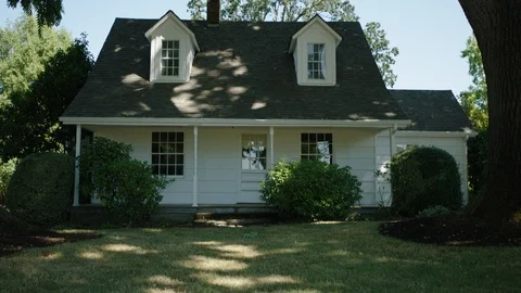 Old white house next to a tree in slow motion 1 Stock Footage 104269181