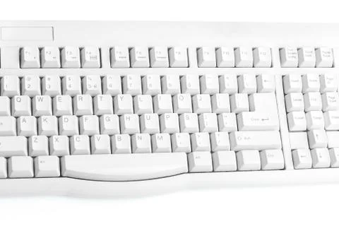 Old white keyboard on white background closeup Foto stock