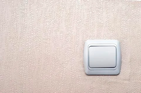Old White Light Switch on Pinky Textured Wallpaper Background with Copy Space Stock Photos