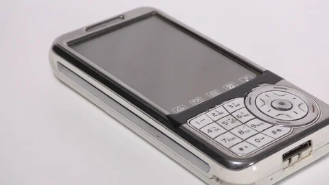 An old white mobile phone with large display moving Stock Footage 111887795