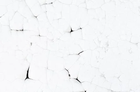 Old white paint on wall. Surface texture with cracked peeling paint. Stock Photos
