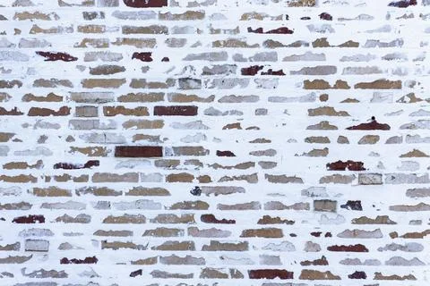 Old white painted brick wall texture background with exposed red bricks Stock Photos