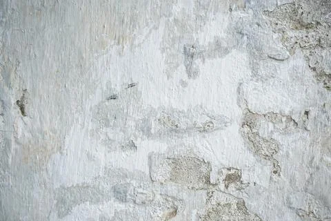 Old white painted limewashed plaster wall texture or background, close-up. Stock Photos