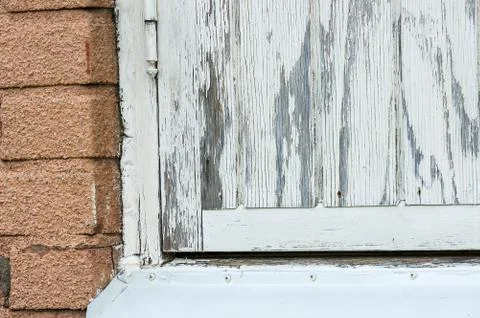 An old white painted window where the paint is chiping of Foto stock