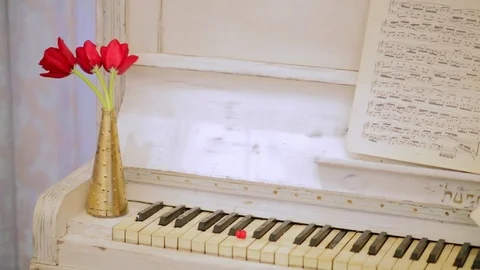 The old white piano with notes and flowers Stock Footage 73348063