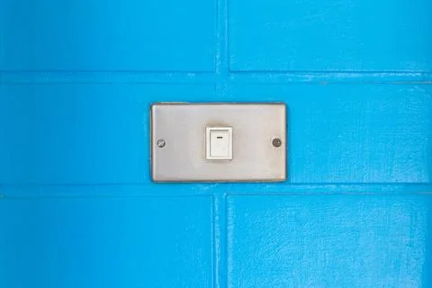 Old white switch on the bue wall Stock Photos