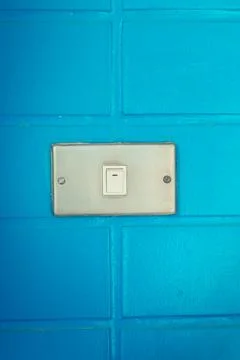 Old white switch on the bue wall Stock Photos
