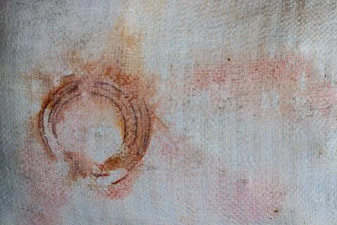 Old white tarp with circular rust, stains, a gunge vintage look in shades of red Stock Photos