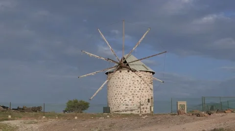 Old white windmill on the hill with the cloudy sky on the background. 4k Video stock 63598851