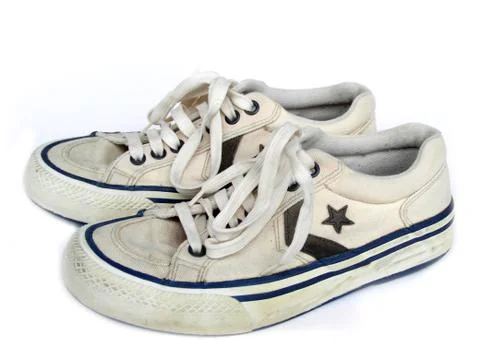 Old white worn sneakers, side view Stock Photos