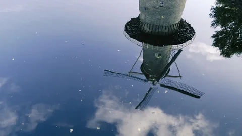 Old wind mill and clouds reflection in water. Stockbeeldmateriaal 118317979
