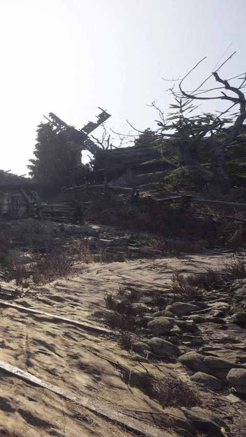Old windmill and abandoned house near rocky path in the daytime Stock Footage 339035657