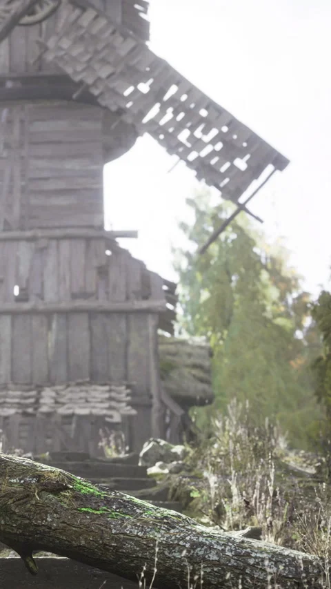 Old windmill beside wooden structure in sunlit rural area with trees Stock Footage 335968597