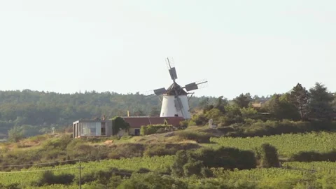 Old windmill, blades spinning in the wind, rural landscape, Europe, Austria. Stock Footage 249961085