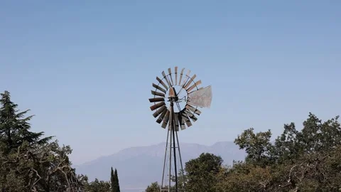 Old windmill blowing in the wind Stock Footage 163376193