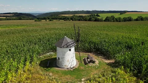 Old windmill in the field. Old stone windmill with wooden blades. Stock Footage 167333378