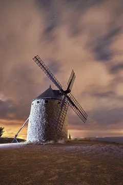 An old windmill in the night with clouds Stock Photos