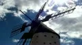 Old windmill in a spanish countryside with blue sky - timelapse HD Footage