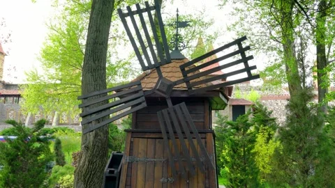 An old windmill with spinning blades on a beautiful background Stock Footage 240527444