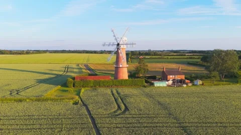 Old windmill stands tall, proud, in golden field Video stock 342614081