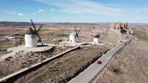 Old windmills in line with the Castillo de la Muela in the background Stock Footage 257778036