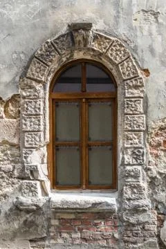 Old window on ancient wall Stock Photos