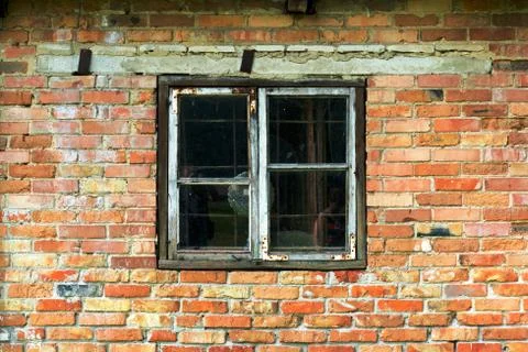 Old window and an old wall of red and yellow brick Stock Photos