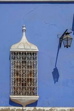 Old window with bars on a colorful facade Stock Photos