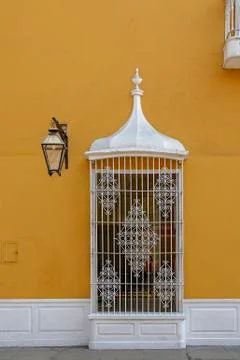 Old window with bars on a colorful facade Stock Photos