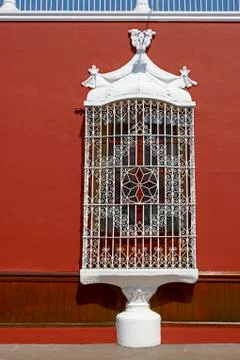 Old window with bars on a colorful facade Stock Photos
