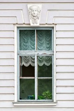 Old window with a bas-relief. Stock Photos