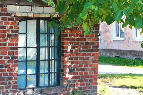 Old window of a brick house Stock Photos