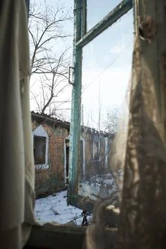 Old window with cobweb in old abandoned yard. View from indoor Stock Photos