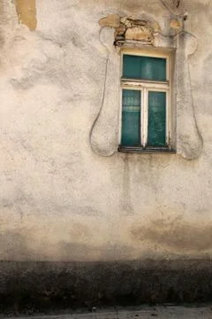 Old window on a concrete wall. Outside, house. Stock Photos