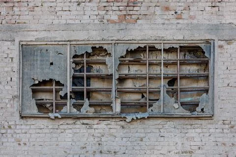 Old window covered with torn ruberoid material and old wooden planks on white Stock Photos