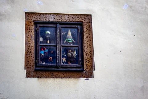 Old window display with small figurines of gnomes and toys, Stock Photos