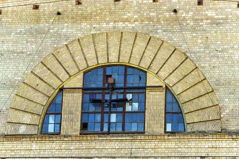 Old window in the form of an arch with broken glass Stock Photos