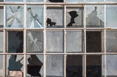 Old window frame of industrial building with broken glass Stock Photos