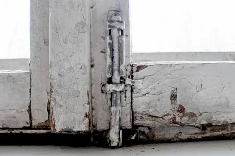 Old window frame with a latch. Stock Photos