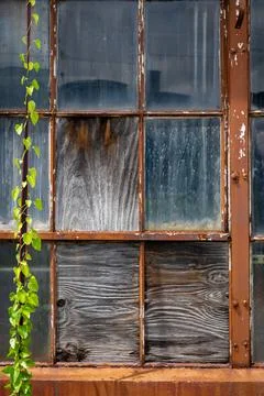 Old window has been boarded up with plywood and is dirty, Stock Photos