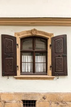 Old window made of stone and wood with brown shutters Stock Photos